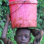 boy carrying water for cover